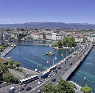 aerial view of city buildings near body of water during daytime