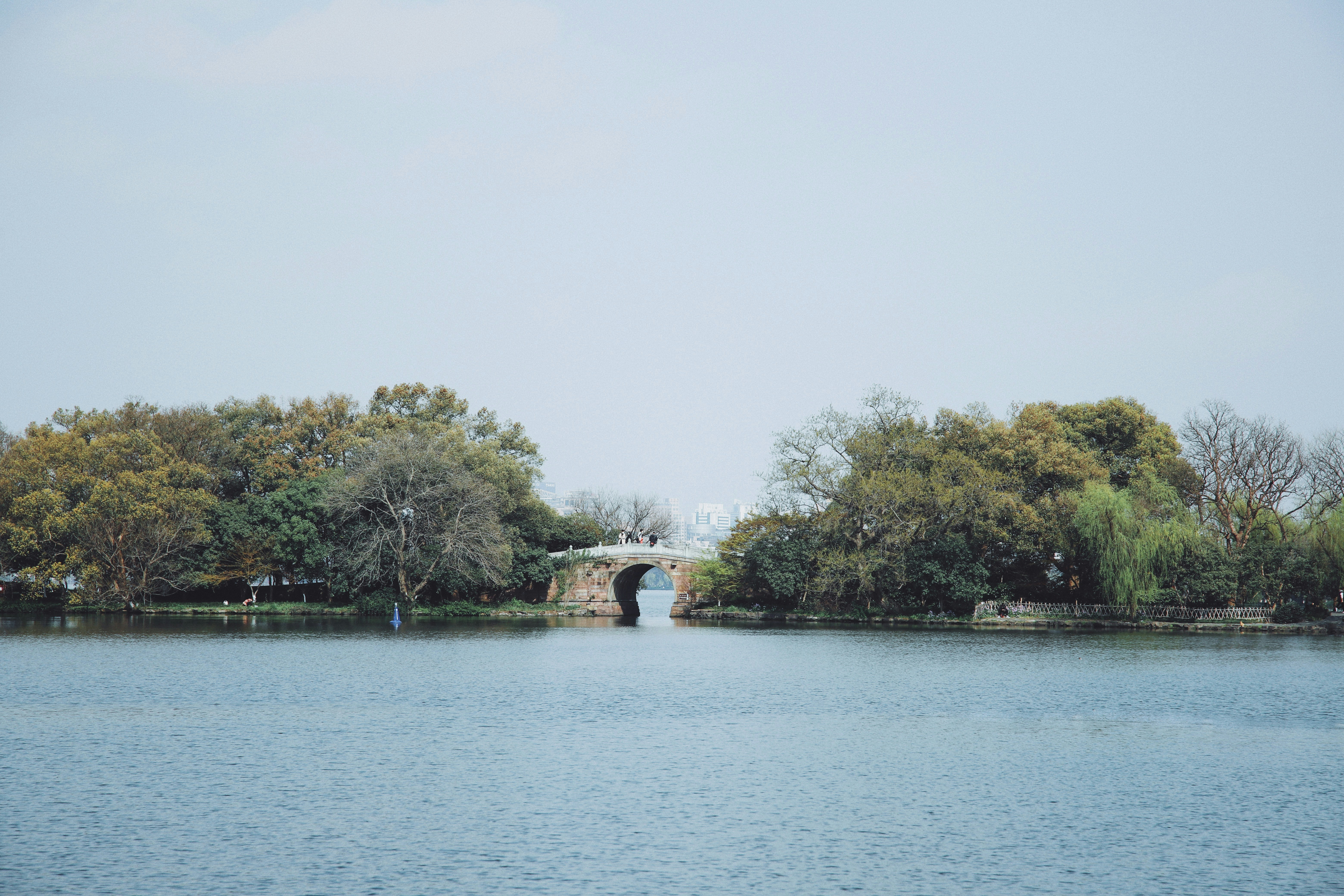 woman in white dress standing on dock during daytime