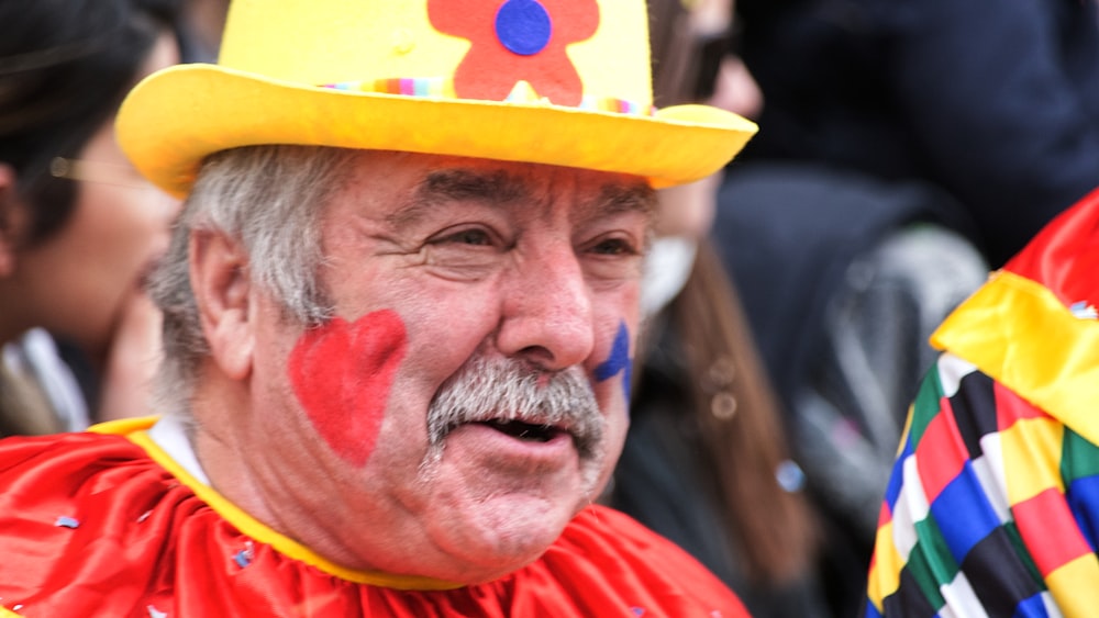 man in red shirt wearing yellow hat