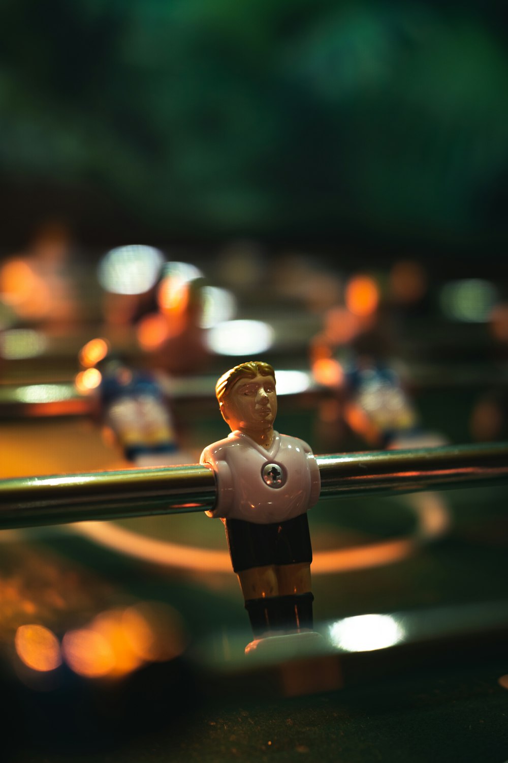 brown wooden figurine in tilt shift lens