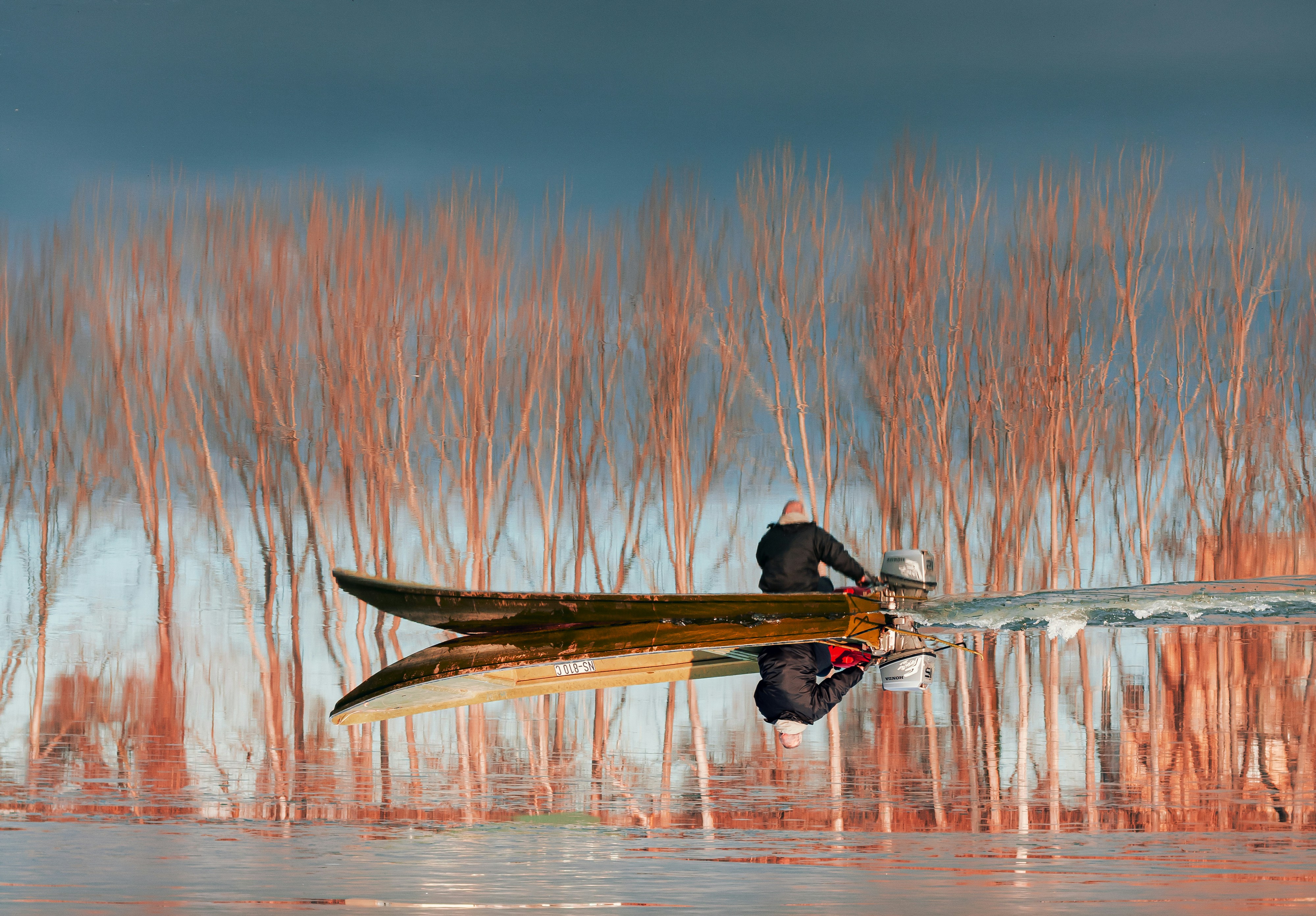 man in black jacket riding on yellow kayak on body of water during daytime