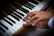 Close-up of hands gracefully playing piano keys during a wedding celebration.