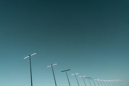 Government project featuring rows of modern solar street lights along a city road.