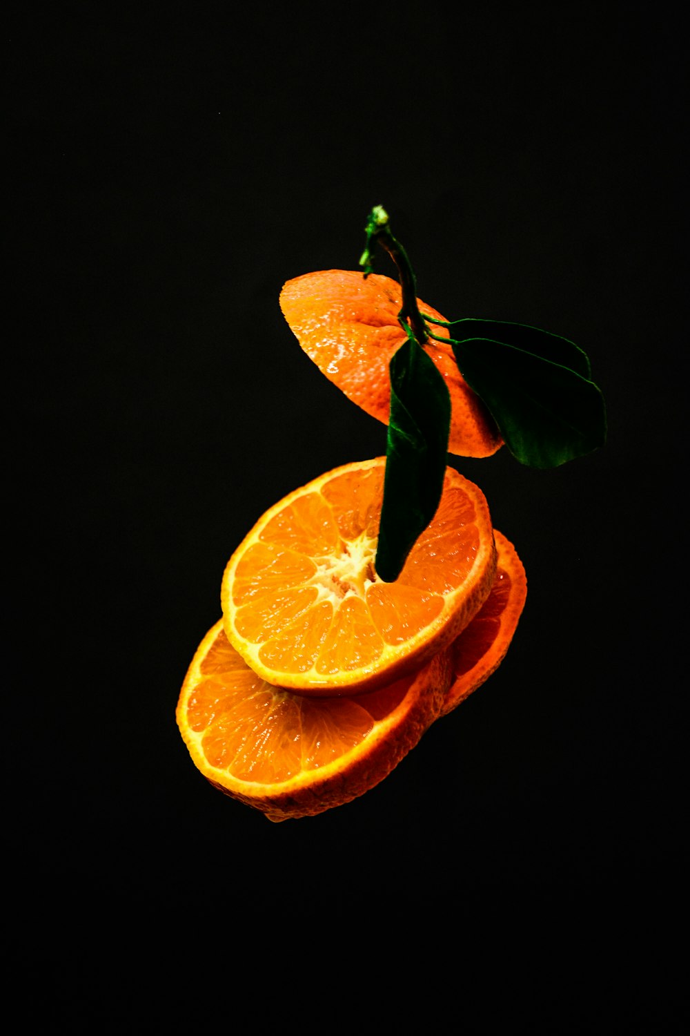 sliced orange fruit with black background