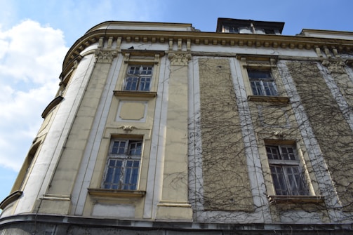 Image depicting painting of a building exterior by skilled painters.