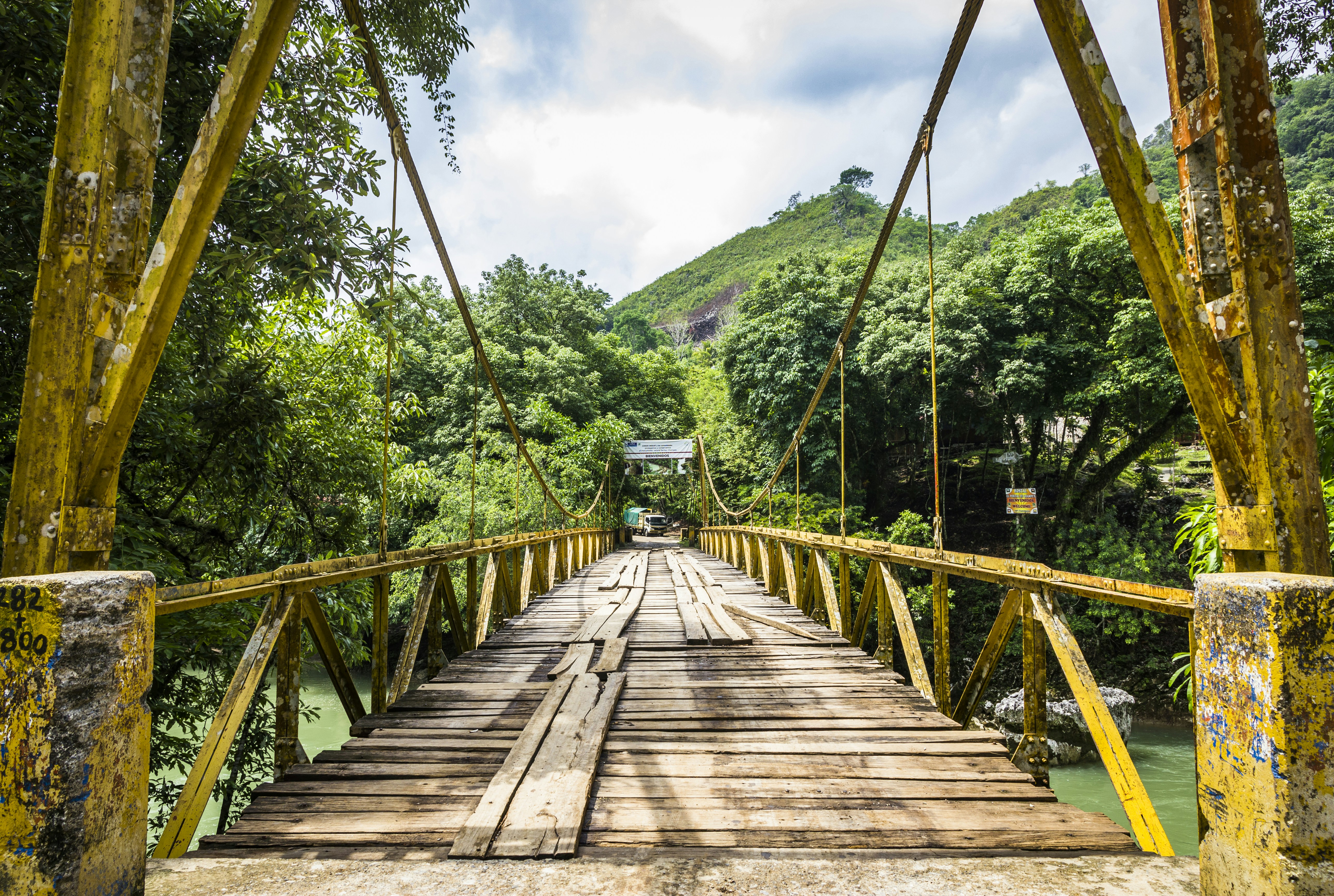 Brown wooden bridge over green mountains during daytime photo – Free ...