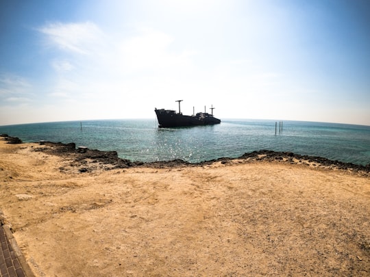 black ship on sea under blue sky during daytime in Kish Iran