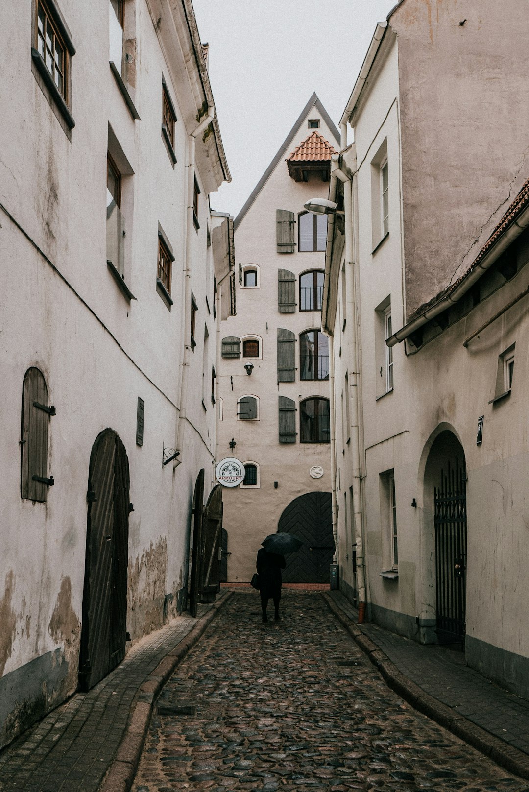 man in black jacket walking on street during daytime