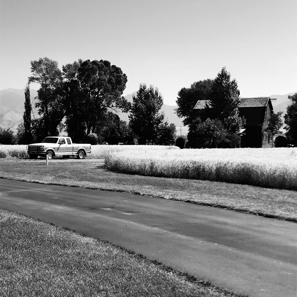 grayscale photo of car on road