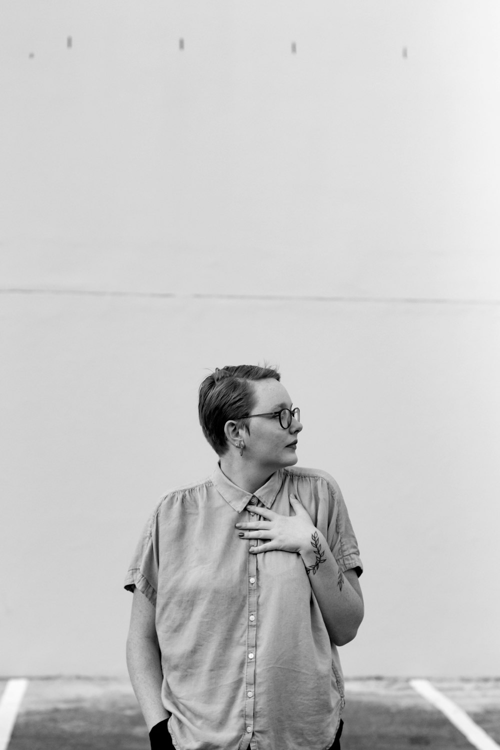 grayscale photo of woman in button up shirt