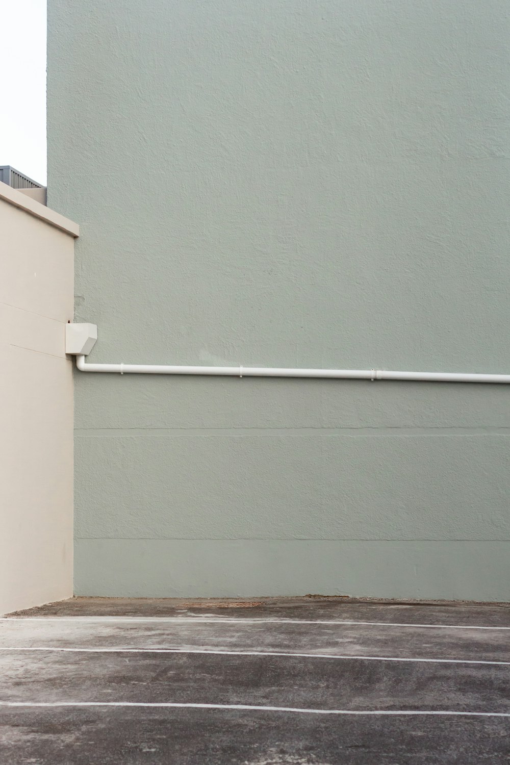 white pipe mounted on green wall