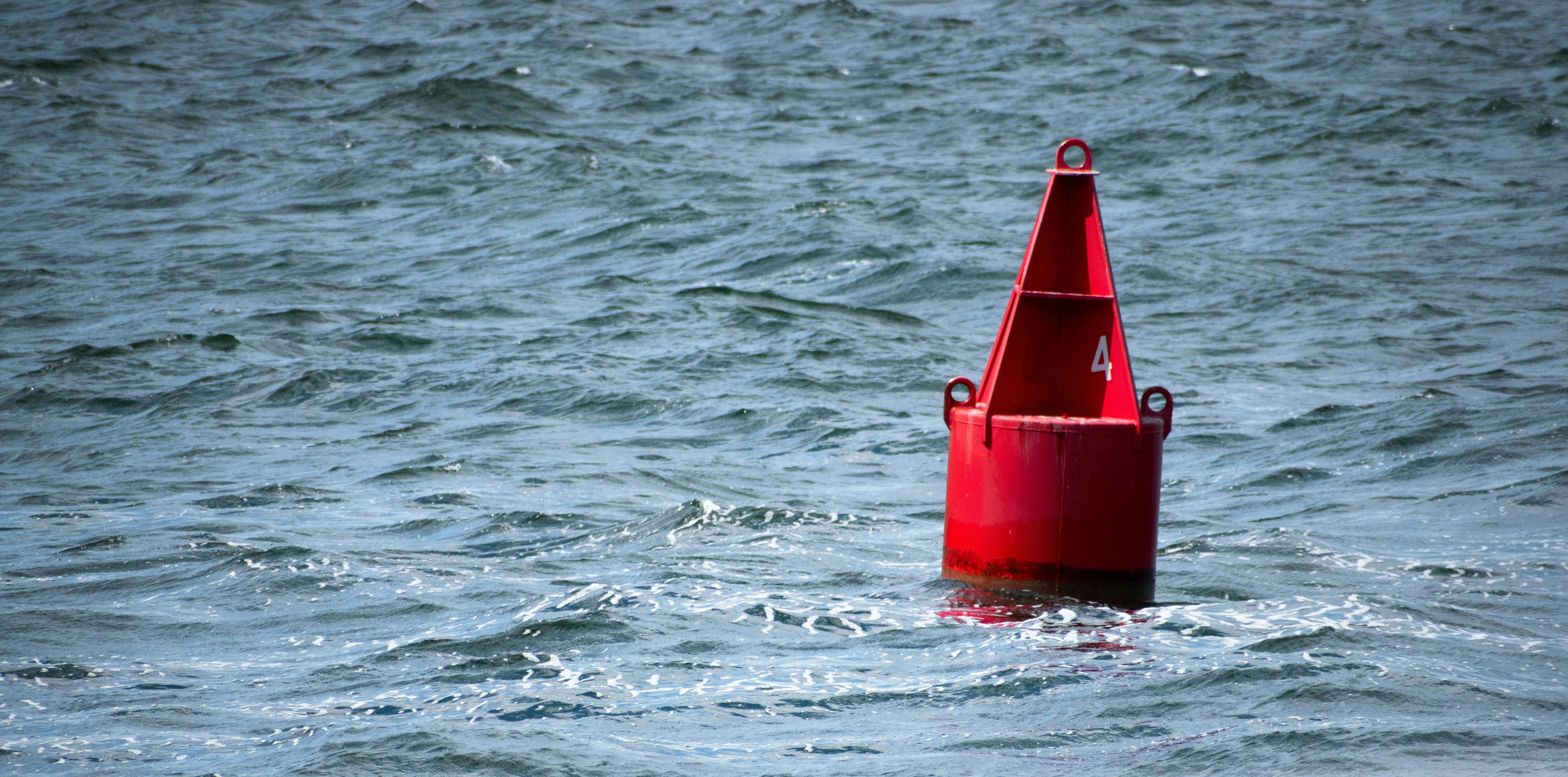red plastic bucket in water