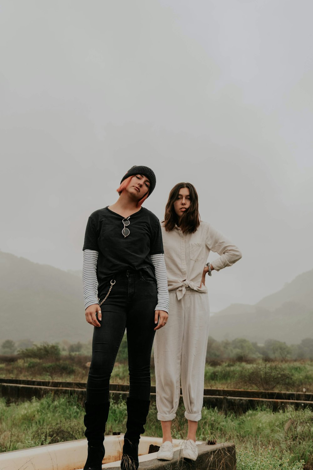 woman in white long sleeve dress standing beside woman in black long sleeve shirt