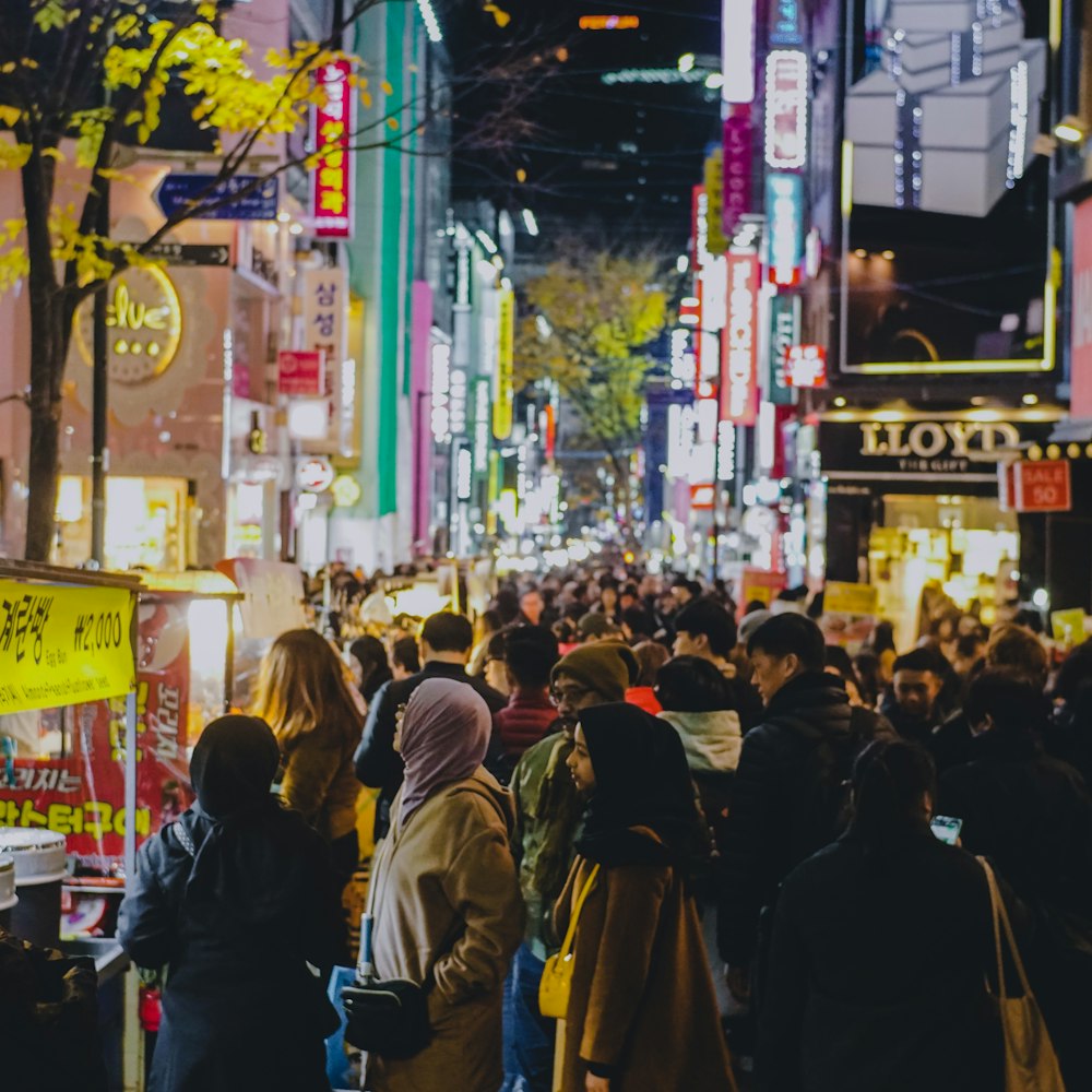 people walking on street during nighttime