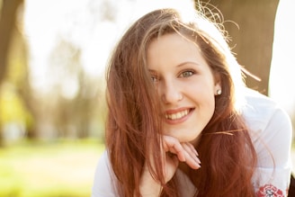 smiling woman in white shirt