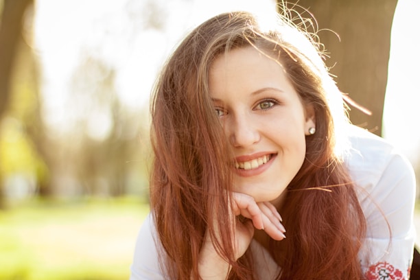 smiling woman in white shirt