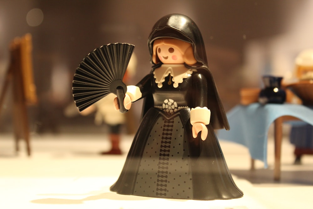 black haired girl in black and white polka dot dress figurine