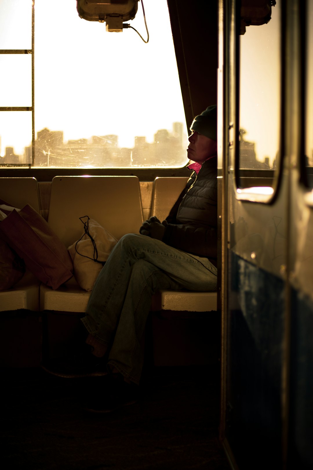 man in black jacket sitting on train seat