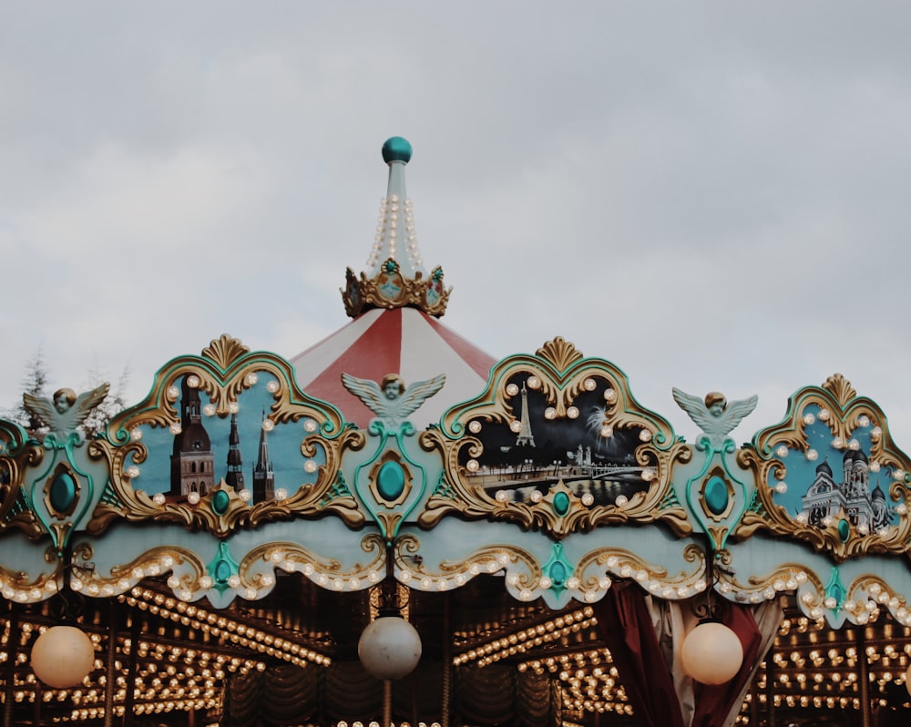 blue and green carousel under blue sky during daytime