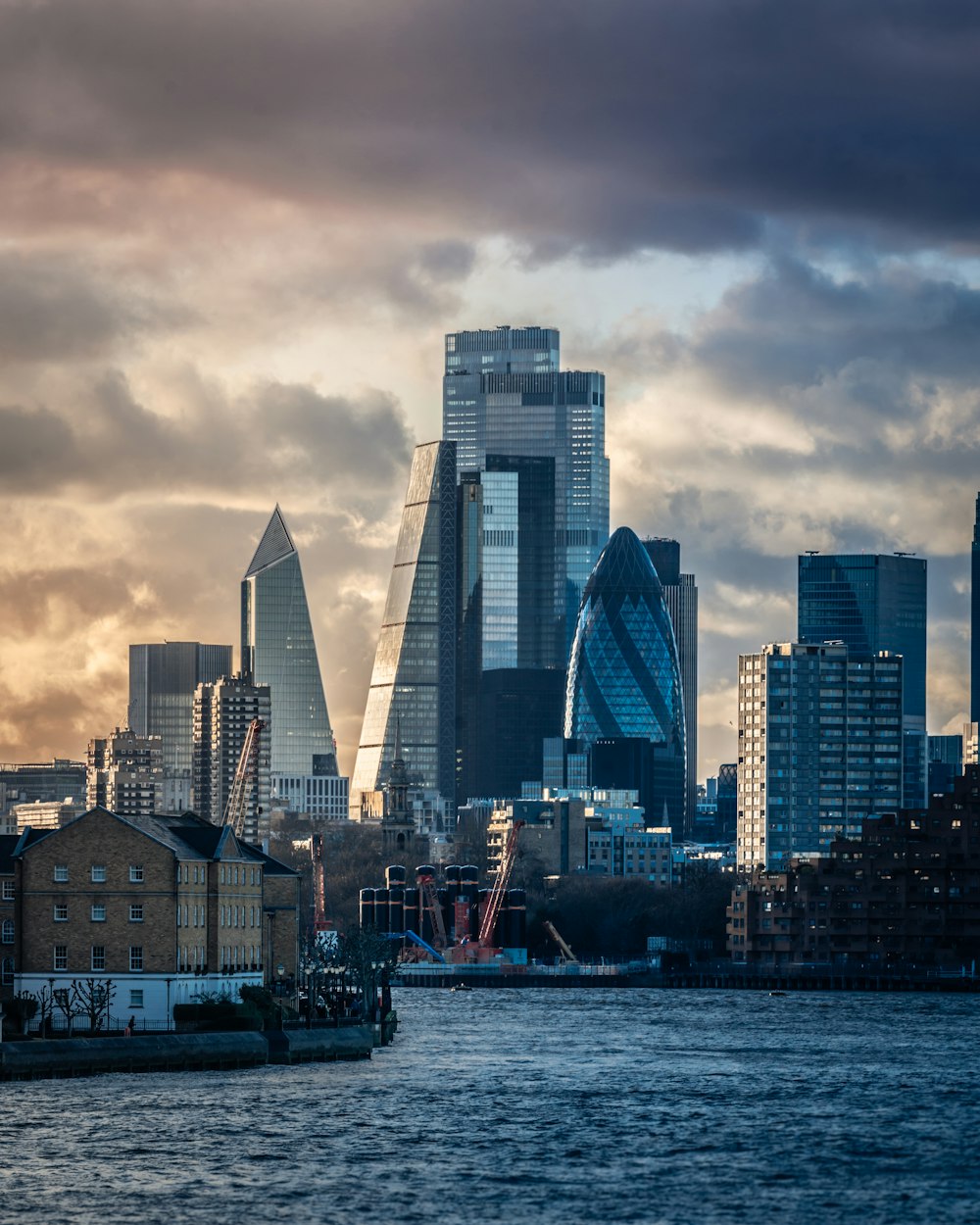 city skyline under cloudy sky during daytime