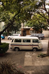 white van parked on sidewalk during daytime