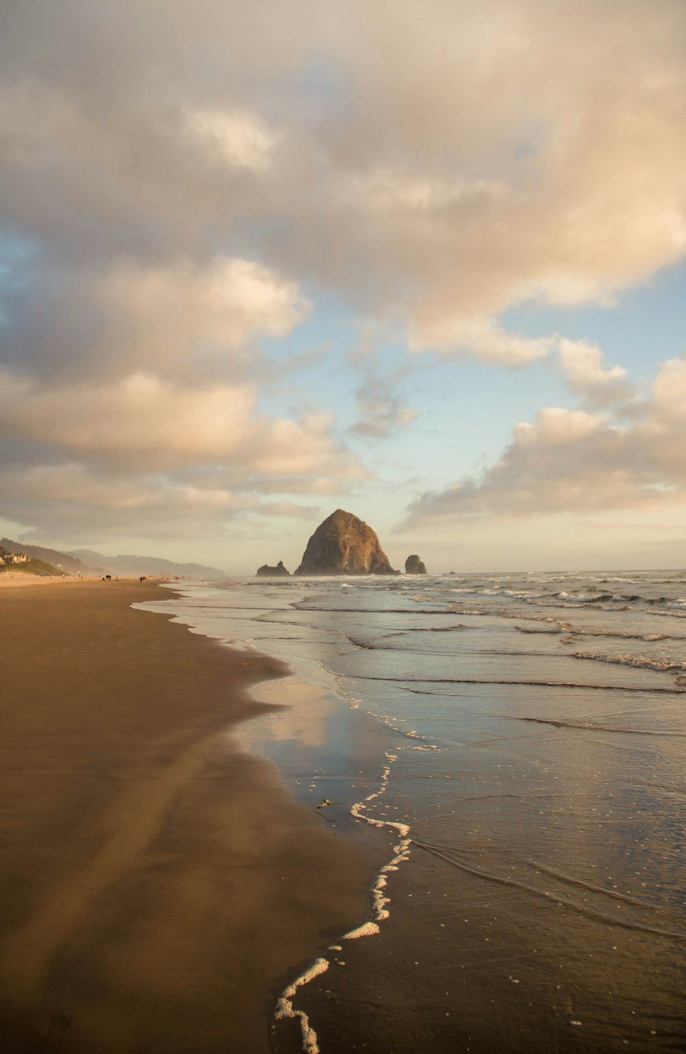 brown rock formation on sea shore during sunset