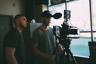 man in gray crew neck t-shirt standing beside man in gray crew neck t-shirt
