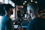 man in blue crew neck t-shirt using black video camera