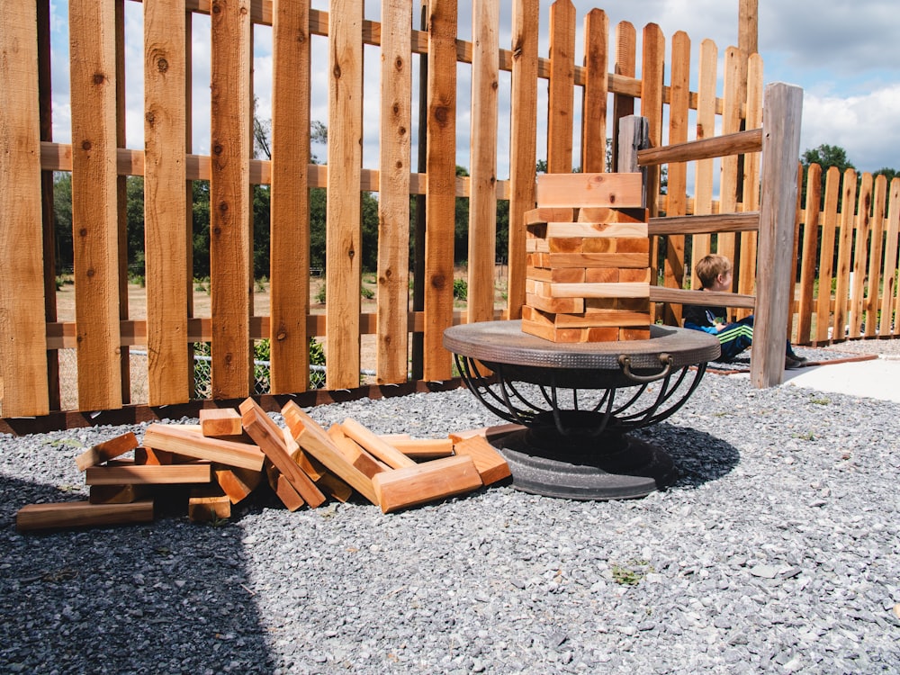 Backyard picket fence with a fire bowl patio