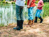 Children playing near a small pond with native plants in the eco-village.