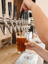 Interior shot of Dorf Brewhouse showing the side pull Lukr Czech tap in action with creamy foam on a freshly poured beer.