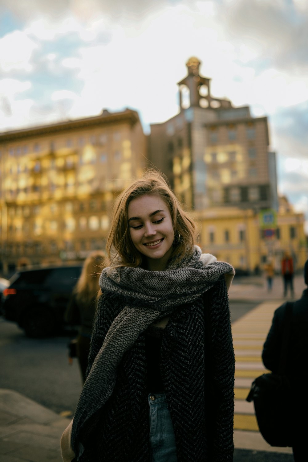 woman in black and white sweater smiling