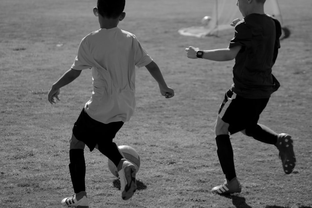 grayscale photo of man in white shirt and black shorts