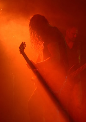 man playing guitar on stage