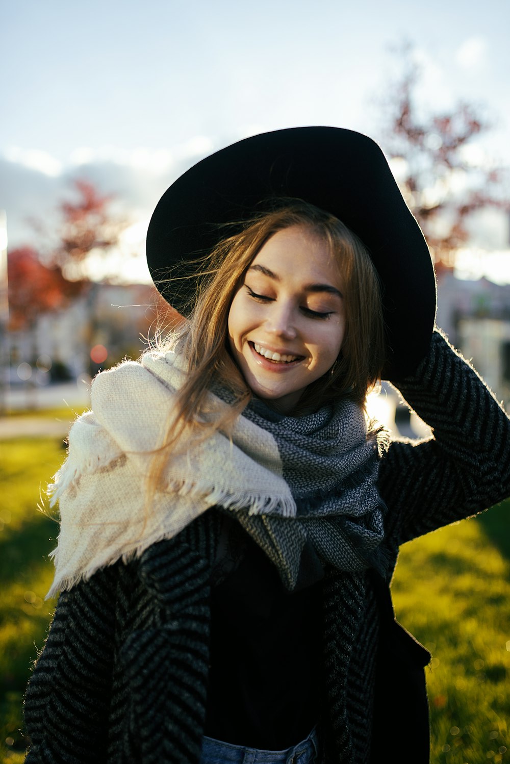 a woman wearing a black hat and scarf