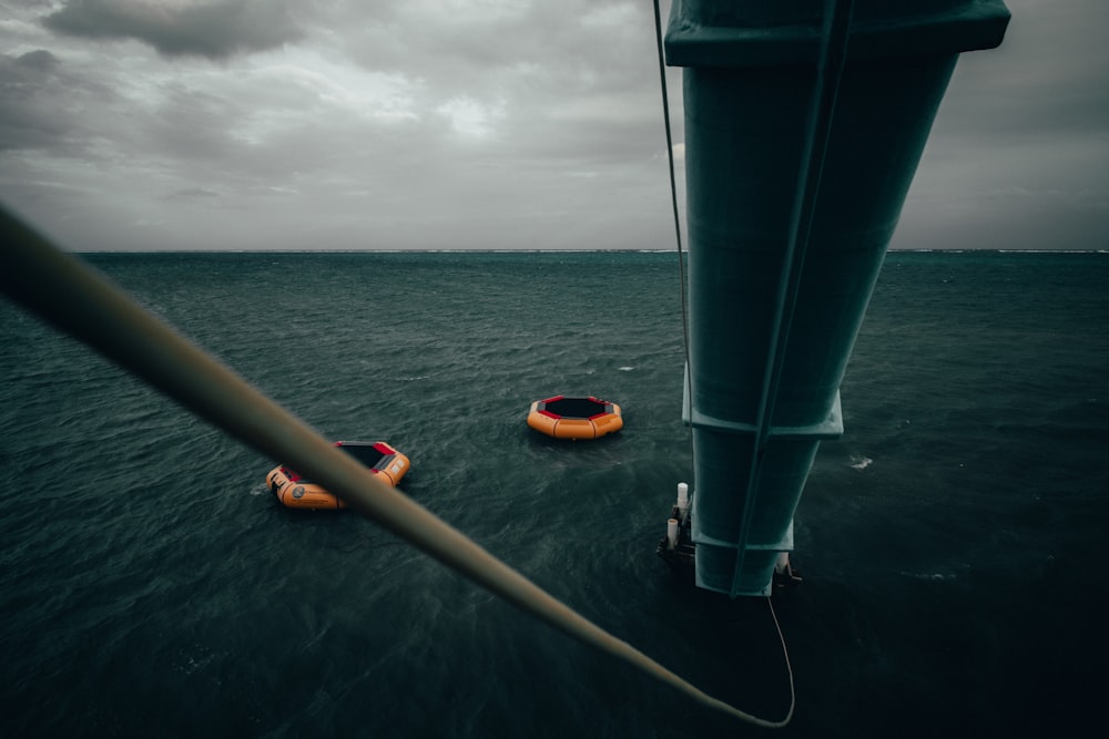 yellow and black kayak on sea under white clouds during daytime