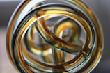 Close-up of a shimmering resin sculpture with intricate swirling patterns.