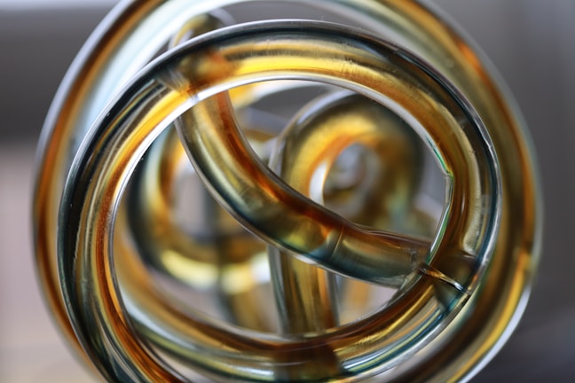 Close-up of a shimmering resin sculpture with intricate swirling patterns.