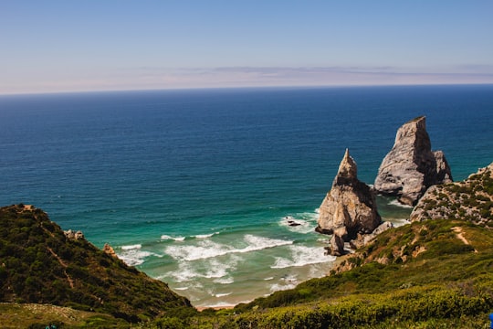 brown rock formation on sea during daytime in Sintra-Cascais Natural Park Portugal