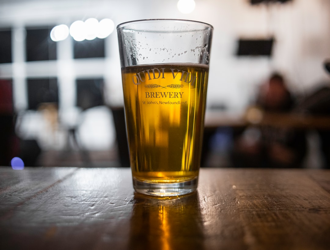 clear drinking glass with yellow liquid