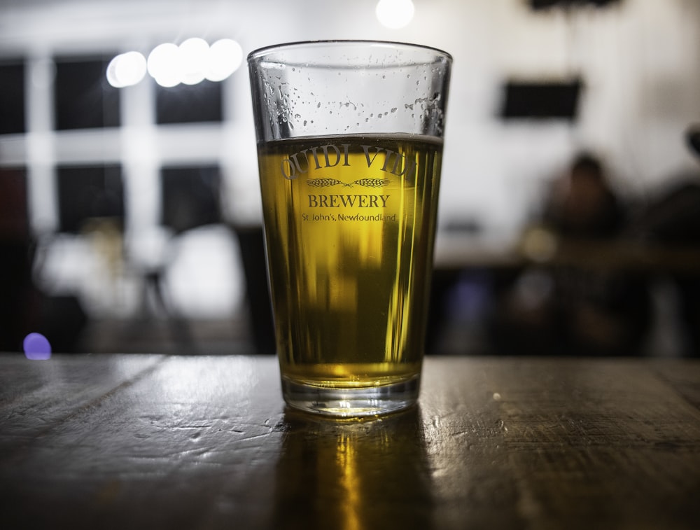 clear drinking glass with yellow liquid