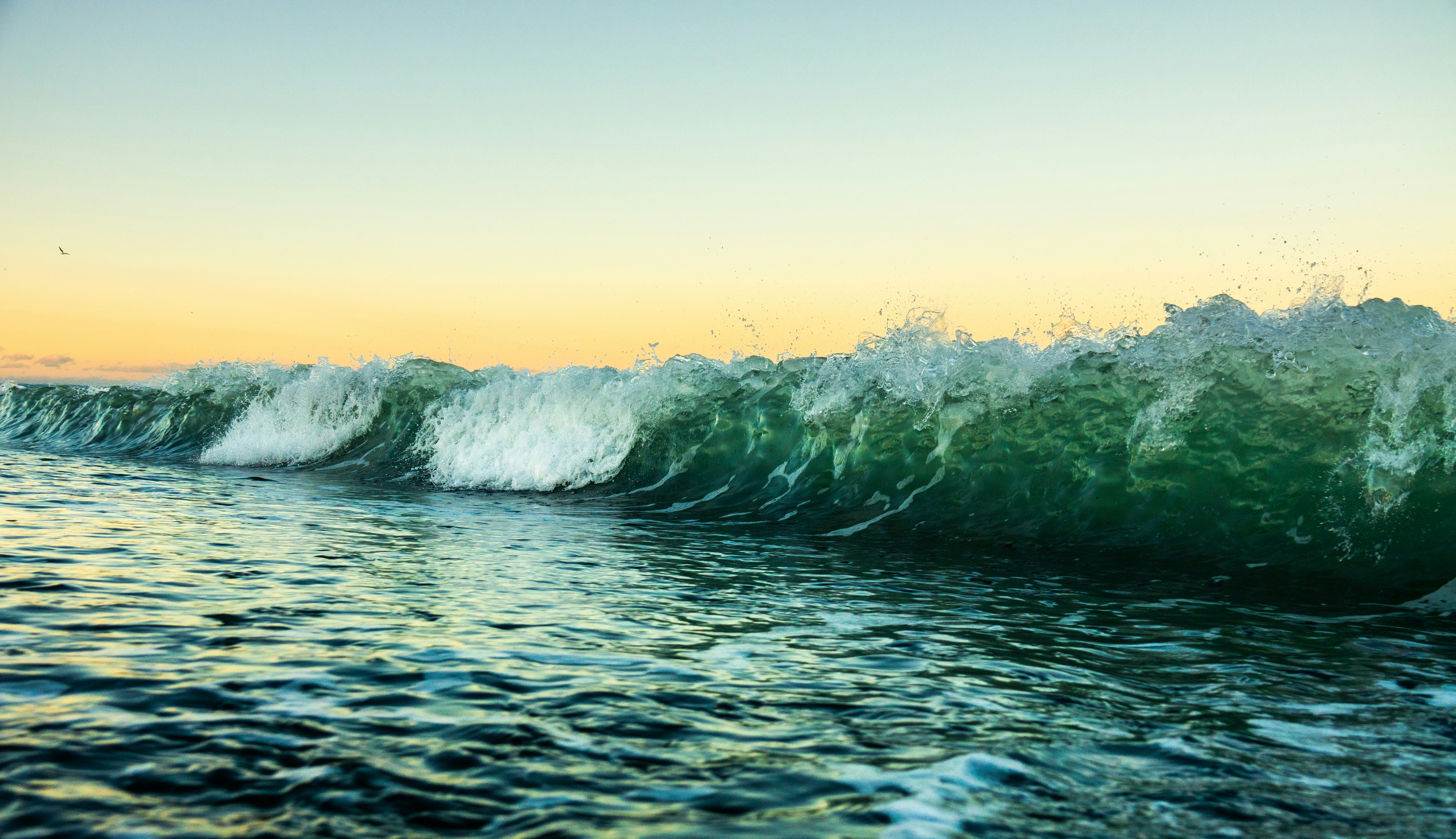 ocean waves crashing on shore during daytime