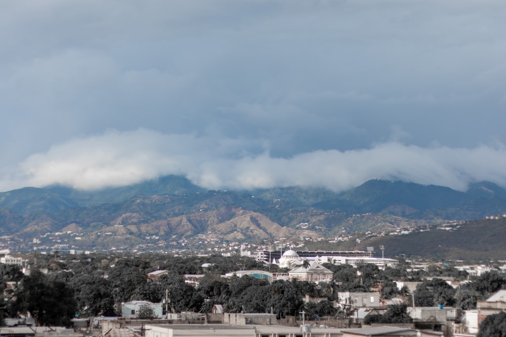 aerial view of city buildings under cloudy sky during daytime