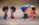 Two pairs of small figurines depicting young couples facing each other. The background is softly blurred to enhance the focus on the figurines. One pair stands facing each other, while the other pair is sitting, creating a warm, playful atmosphere.