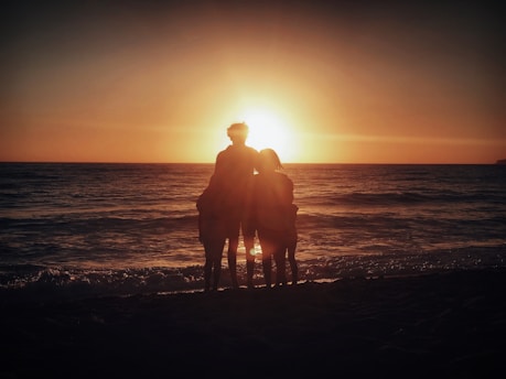 A happy family enjoying a scenic beach sunset on a customized vacation.