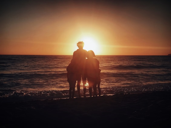 A cozy family gathering on a beach at sunset.