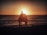 A happy family enjoying a beach sunset together.