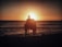 A happy family enjoying the sunset by the lagoon.