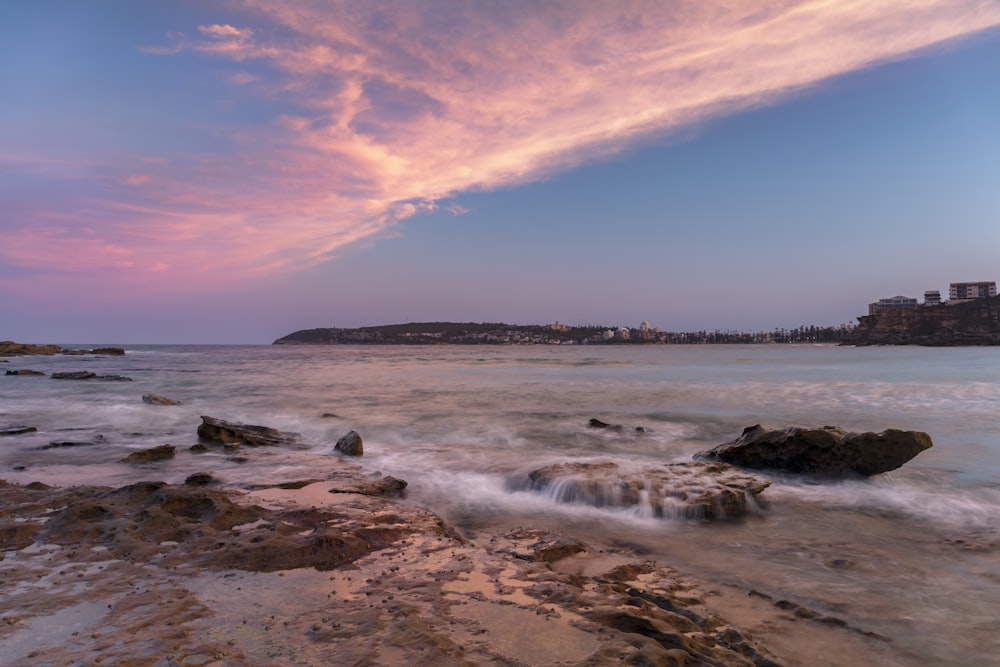 ocean waves crashing on shore during daytime