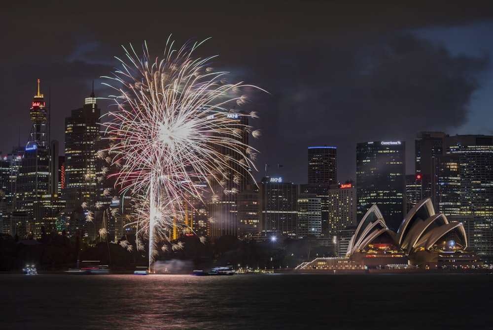 fireworks display over city buildings during night time